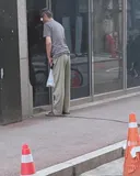 고령의 남성이 출근길 아침, 건물에 노상방뇨